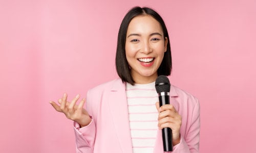 A woman speaks fluently with a microphone
